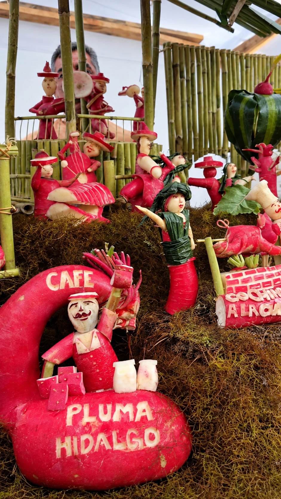 A small village scene with carved figures and tiny cafe signs